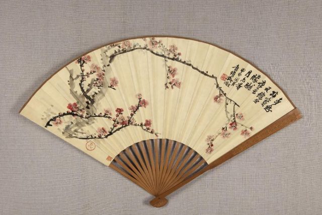 Wu Zheng, folding fan with plum-blossom painting, Republican China (1911–1949), length: 31cm, unfolded width: 51cm, guards & ribs 16 cm, Arts and Crafts Museum, Hangzhou, China.