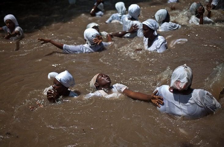 Voodoo believers bathing in a sacred pool - Ramon Espinosa - “Holy Week in Haiti and Dominican Republic - in pictures,” [The Guardian](https://www.theguardian.com/world/gallery/2012/apr/10/haiti-religion#/?picture=388530012&index=14) Voodoo believers dancing during a religious ceremony - Ramon Espinosa - “Holy Week in Haiti and Dominican Republic - in pictures,” [The Guardian](https://www.theguardian.com/world/gallery/2012/apr/10/haiti-religion#/?picture=388530012&index=14) 
