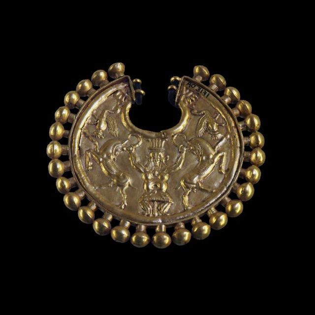 Fig 8: Gold earring with Bes depicted as a master of several goats and birds or geese from Syria – Louvre Museum – AO 3171 – [wikicommons](https://commons.wikimedia.org/wiki/File:Earring_ornated_with_Bes_mastering_two_goats-AO_3171-P5280910-black.jpg)