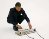 Jeff Mills operating the TR-909 in his “The Exhibitionist” series].jpeg