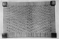 Example of a woven straw seat cover with the same pattern from the previous century - In Seat Weaving, p. 68 [Project Gutenberg](https://www.gutenberg.org/files/53288/53288-h/53288-h.htm)
