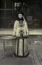 Katherine Carl wearing a long fur-lined garment designed by Cixi herself - Smithsonian Institution