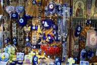 A shop in Boston, MA selling evil eye amulets in a myriad of shapes and forms. Note the combination of the _nazar boncuğu_ and Christian imagery - [wikicommons](https://upload.wikimedia.org/wikipedia/commons/thumb/e/e8/Nazars_Greek_evil_eye_charms.jpg/1024px-Nazars_Greek_evil_eye_charms.jpg)
