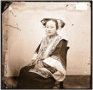 Manchu lady wearing a wire framework of the exaggerated headpiece of liangbatou 兩把頭 hairstyle creating trapezoidal angles - John Thomson (1837-1921) - Wellcome Collection