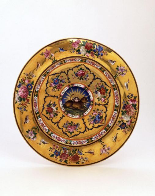 Fig 1: Detail of lion-and-sun emblem, center of the interior from Circular dish, gift from Fath Ali Shah to the British East India Company, signed by Muhammad Jafar, Iran (Tehran), dated AH 1233 / AD 1817-18, gold and painted enamel, D: 32.1cm, M.97-1949, Victoria and Albert Museum, London